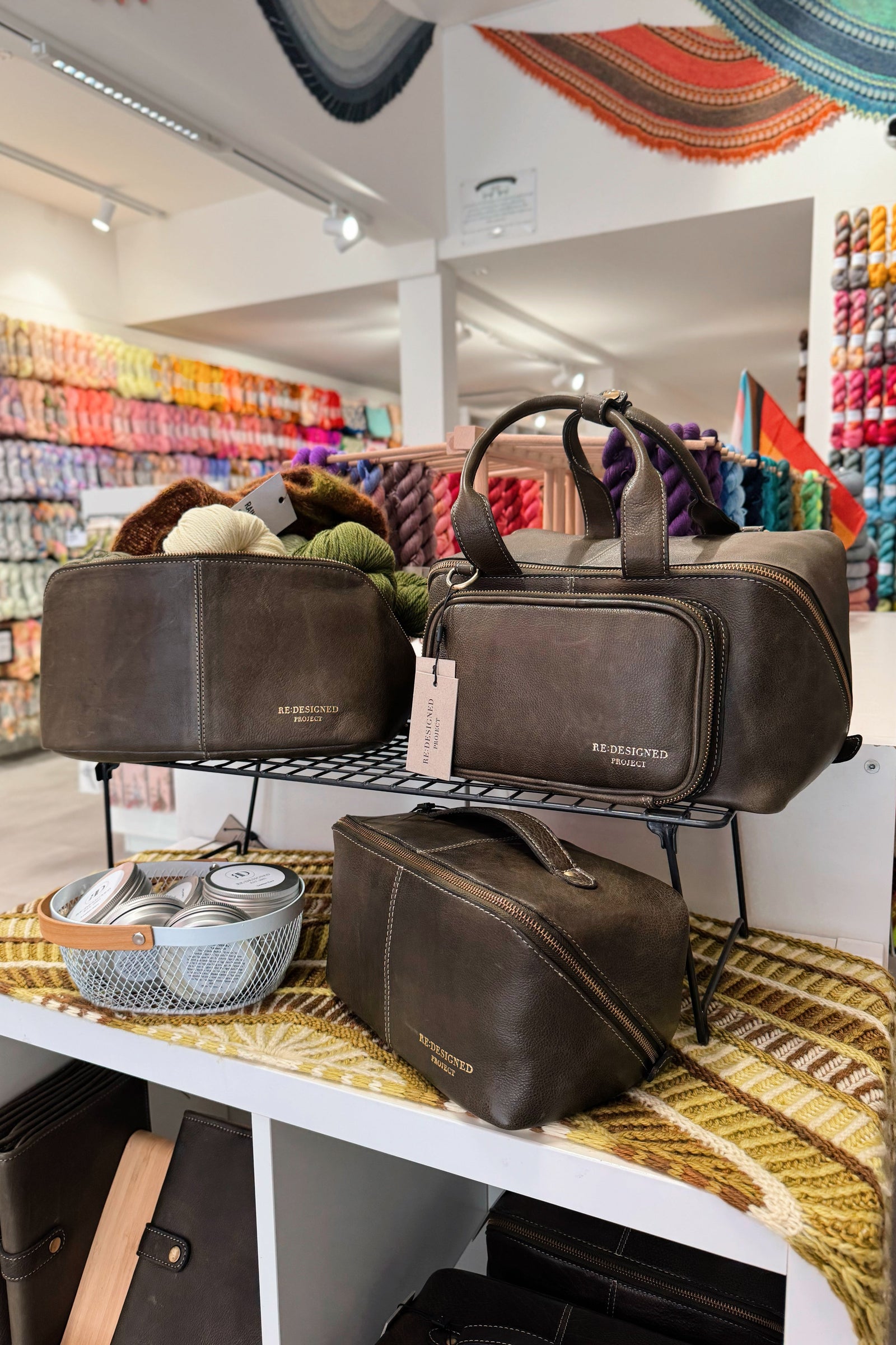 Display of dark green Re:Designed project bags in the store