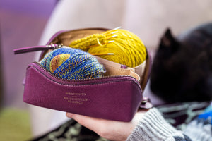 This image shows Project 41 - Aubergine, filled with yarn and needles. The bag is part of a collaboration between Re:Designed and Westknits.