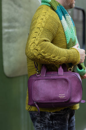 This image shows Stephen West wearing Project 39 - Aubergine. The bag is part of a collaboration between Re:Designed and Westknits.