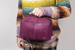 This image shows Project 10 - Aubergine, part of a collaboration between Re:Designed and Westknits. Stephen West is holding it.