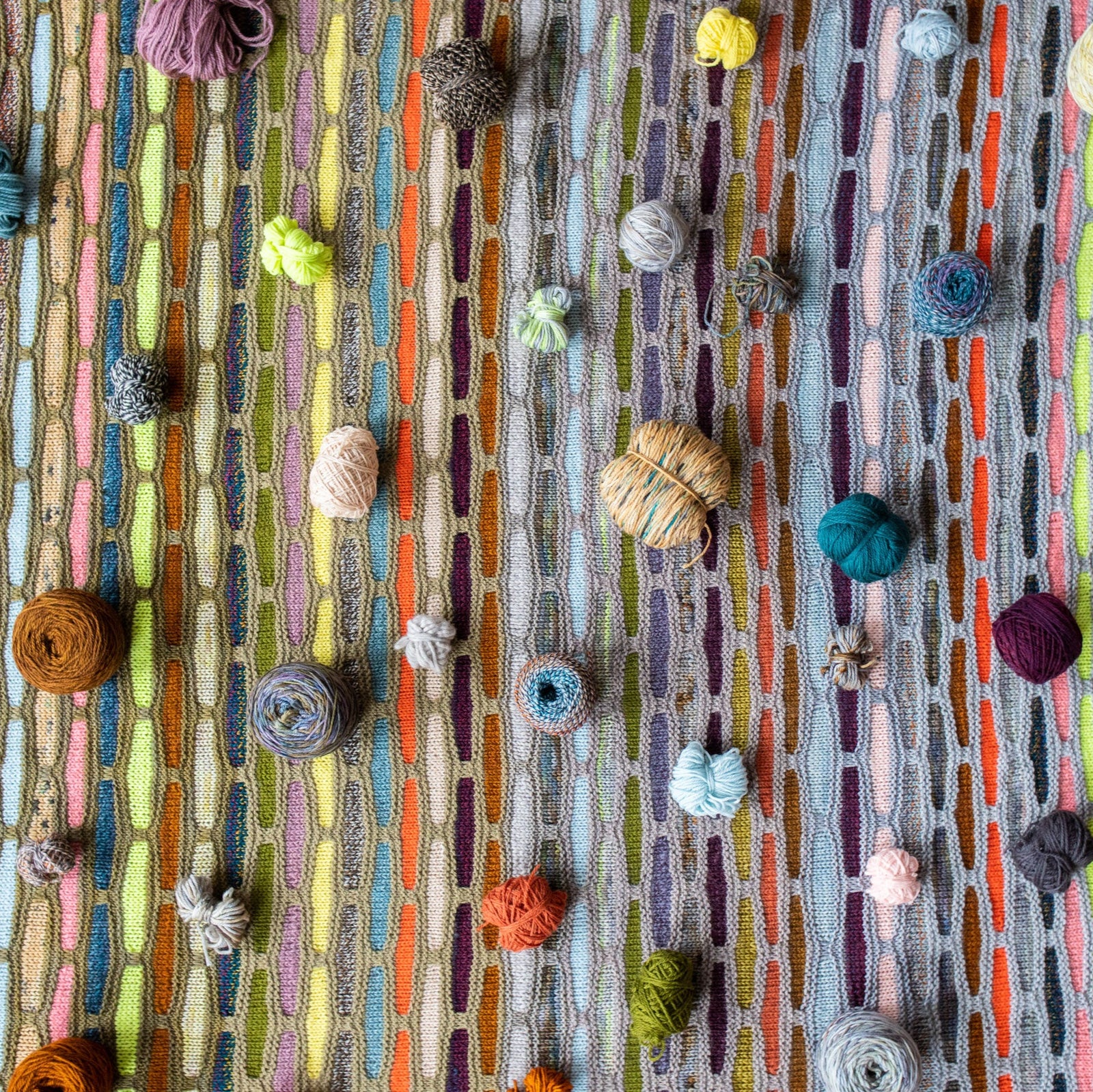 This image shows a detail of a beautifully knitted multicolour sample of the Painting Bricks Blanket from Westknits.