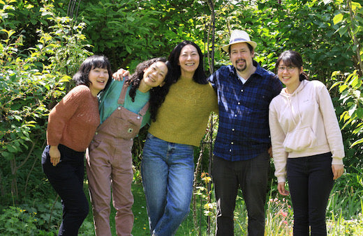 The Mominoki team standing in nature.