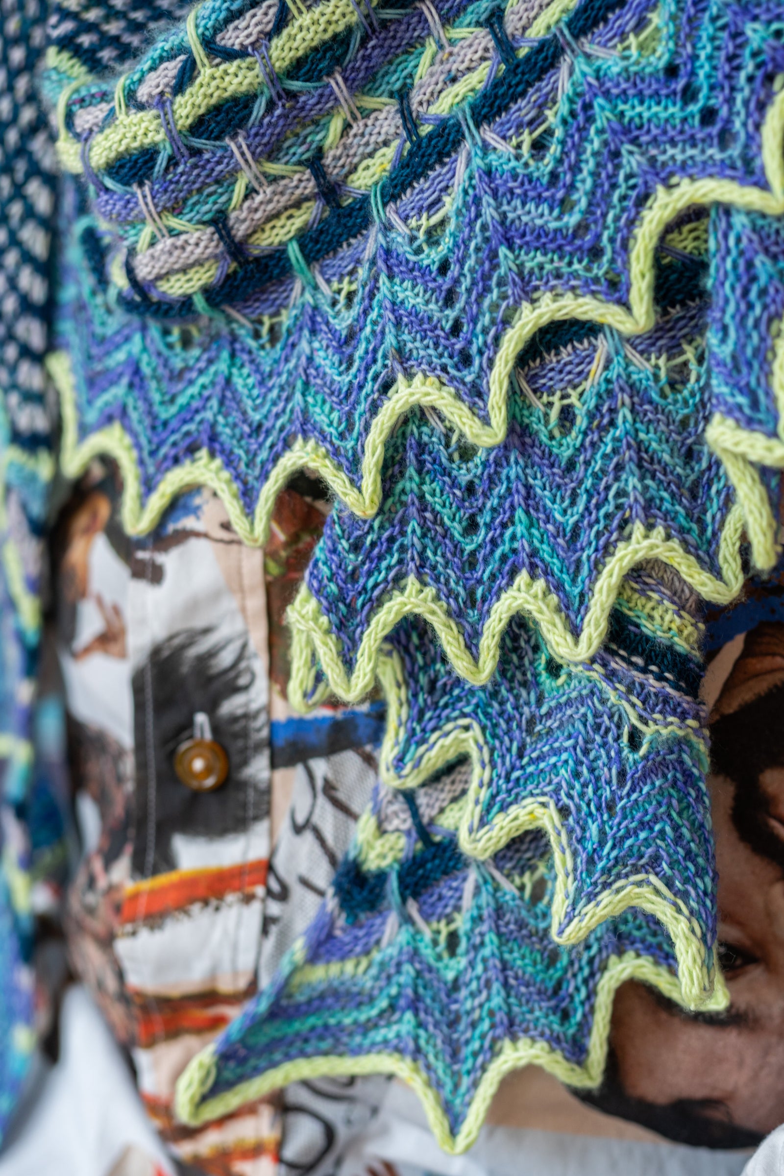 This image shows a detail of the Aurora Cabin Shawl from Westknits in cool shades. 