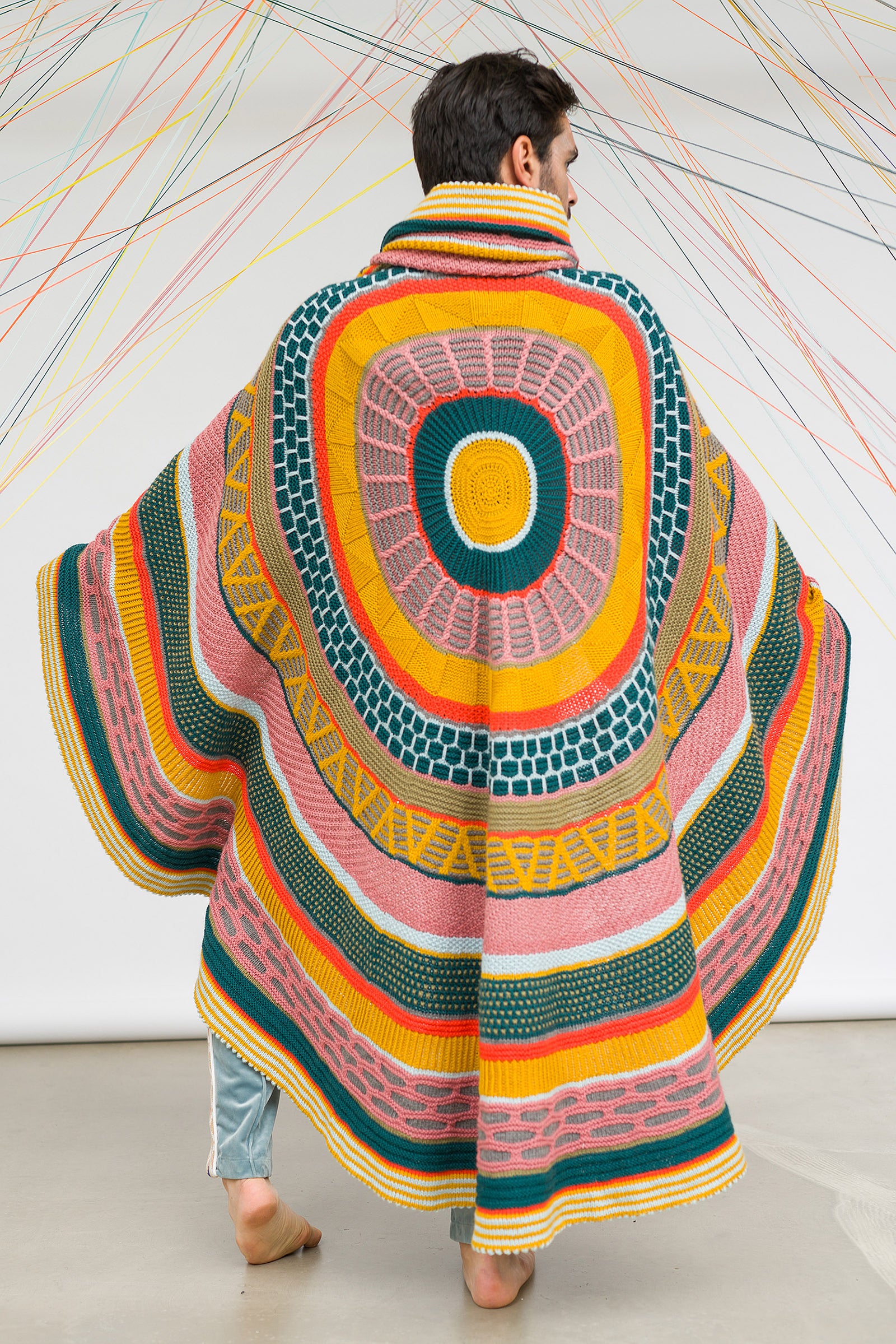 This image shows a beautifully knitted sample of the Fantastitch Blanket by Westknits in various colours, including green, pink, yellow, and coral tones. 