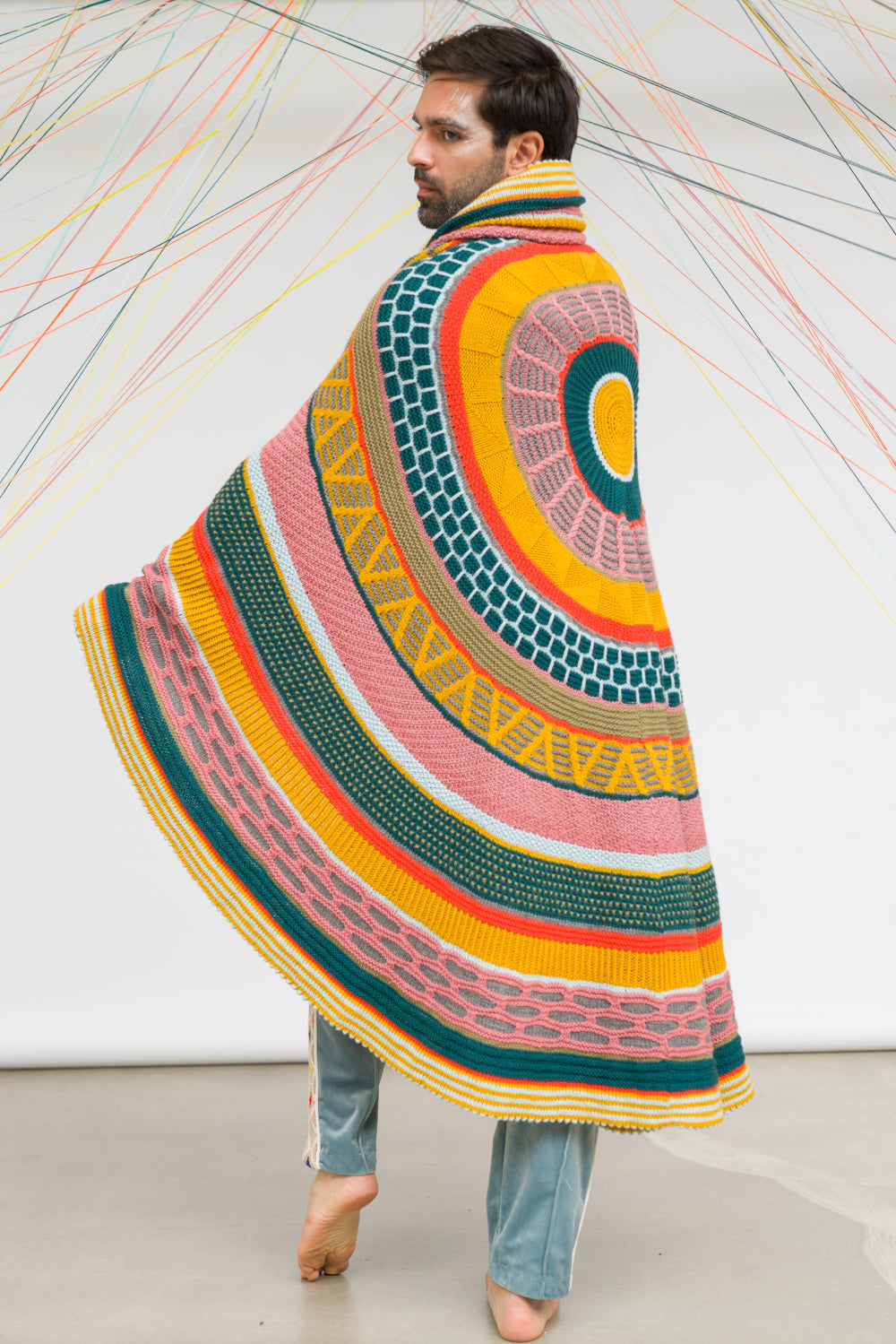 This image shows a beautifully knitted sample of the Fantastitch Blanket by Westknits in various colours, including green, pink, yellow, and coral tones. 