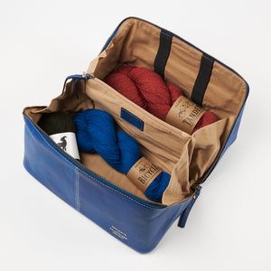 This image shows a denim project bag from the Westknits x Re:Designed collaboration filled with West Wool yarn. 