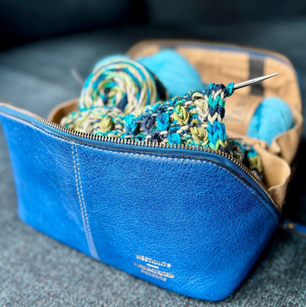 Denim blue Re:Designed project bag filled with colourful yarn. 