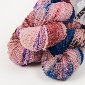 This image shows 3 skeins of Qing Fibre Teddy in Cornflower in a pyramid on a white background. 