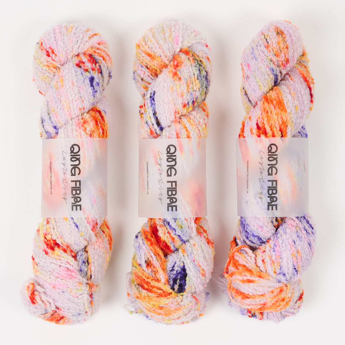 This image shows 3 skeins of Qing Fibre Teddy in Pufferfish on a white background. 