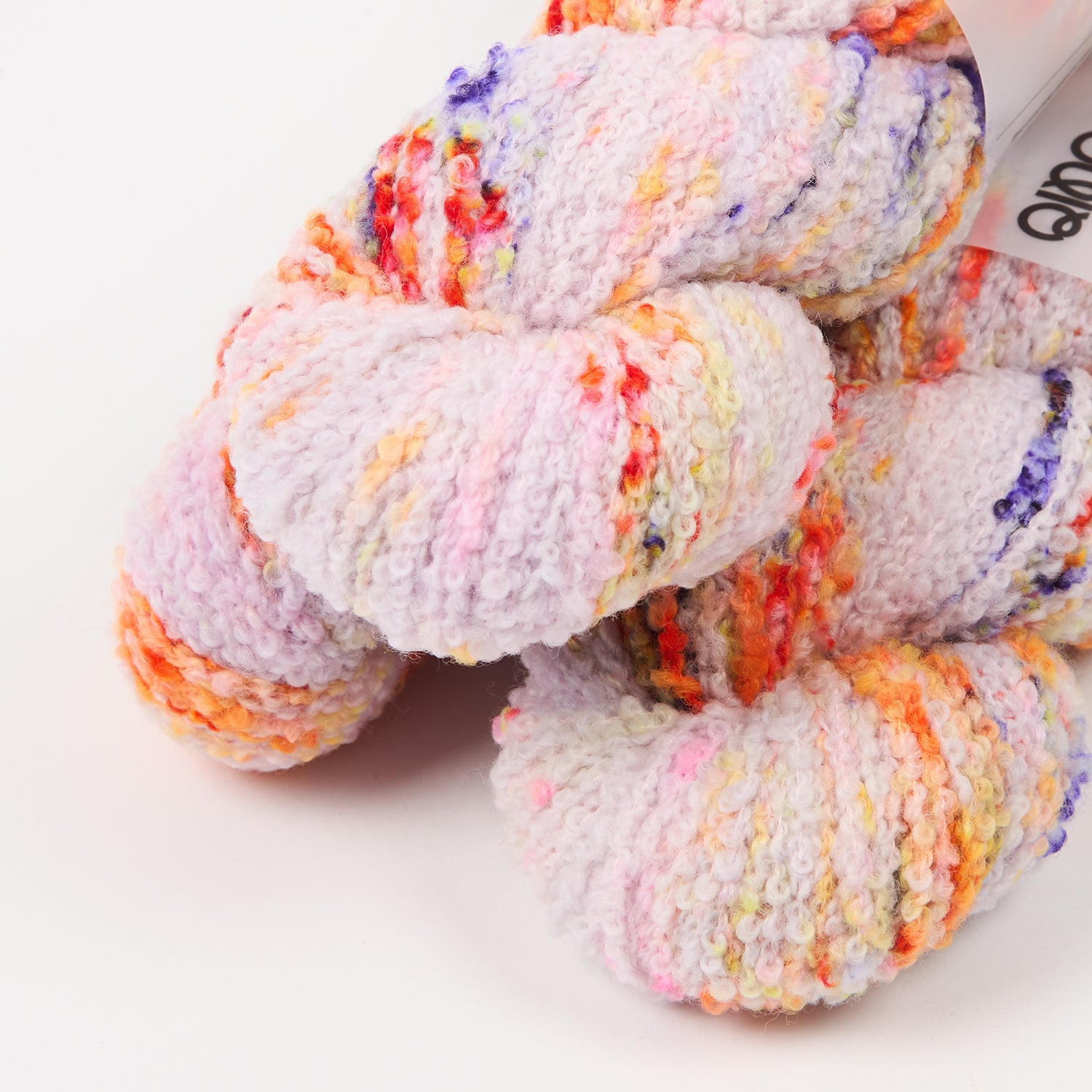 This image shows 3 skeins of Qing Fibre Teddy in Pufferfish on a white background. 