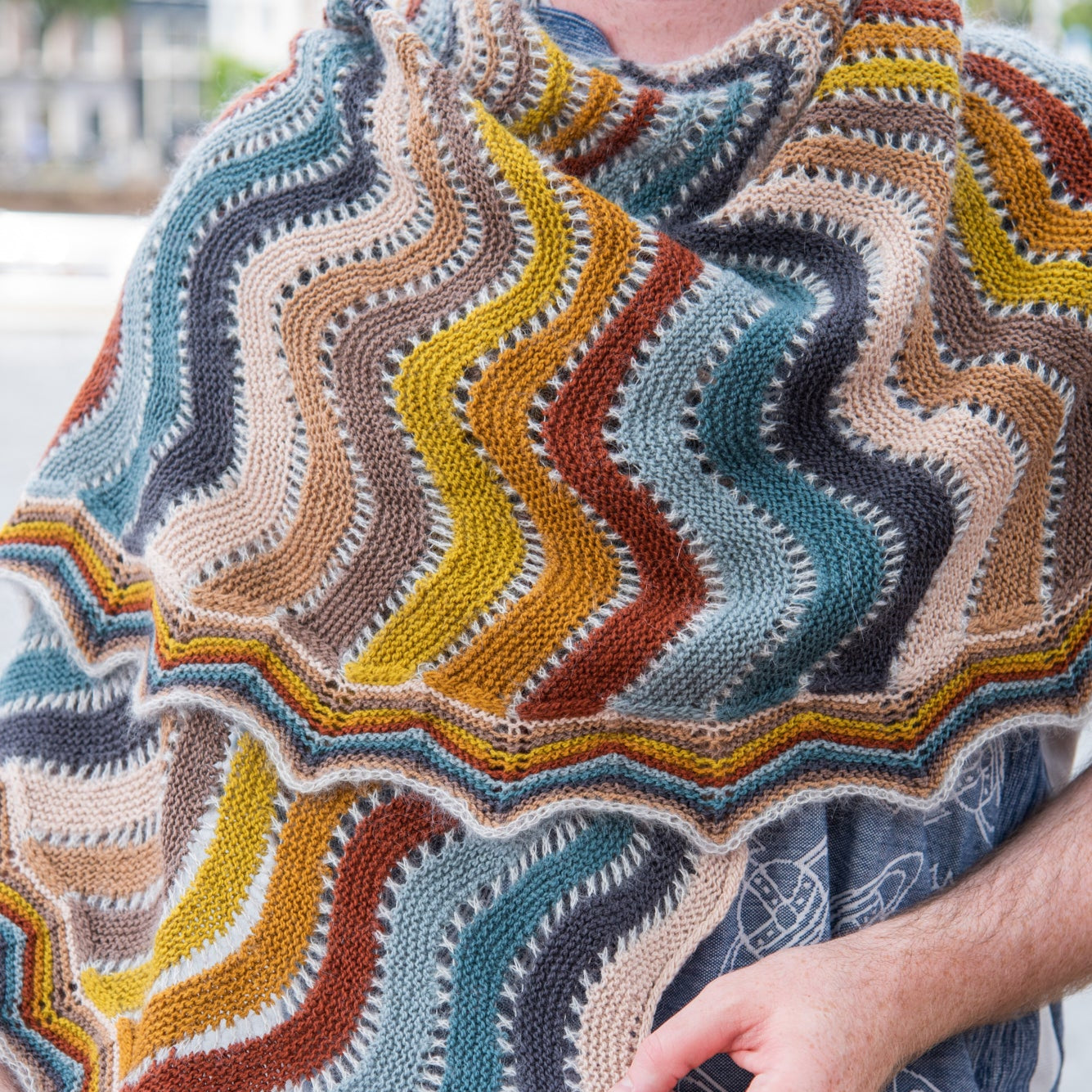 This image shows a detail of a beautifully knitted multicolour sample of the Replendence Shawl by Westknits. 