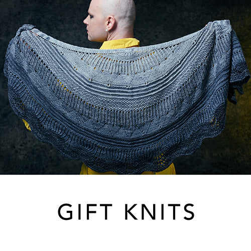 This image advertises Gift Knits from Stephen & Penelope. The image shows Stephen West holding a beautifully knitted sample. 